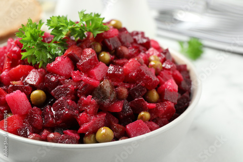 Traditional Russian salad vinaigrette in bowl, closeup