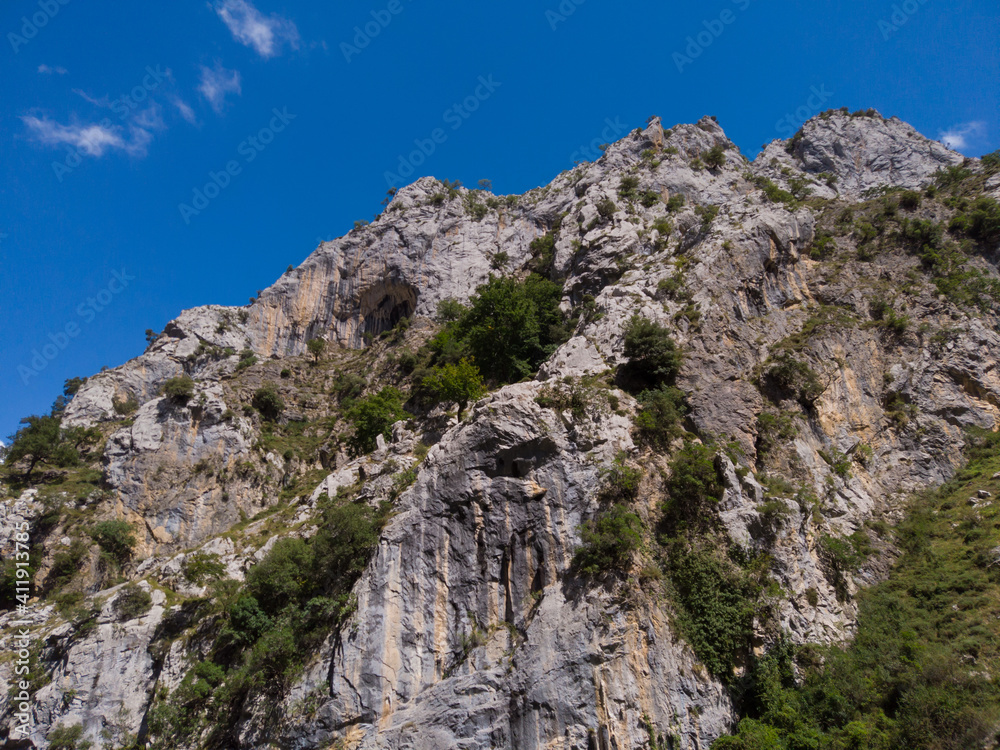 The Cares Route in the heart of Picos de Europa National Park, Cain-Poncebos, Asturias, Spain. Narrow and impressive canyon between cliffs, bridges, caves, footpaths and rocky mountains.