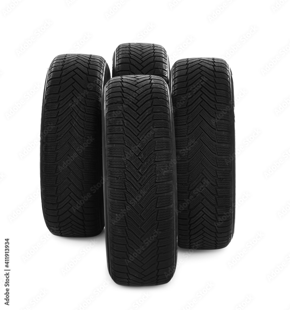 Set of new winter tires on white background Set of new winter tires on white background