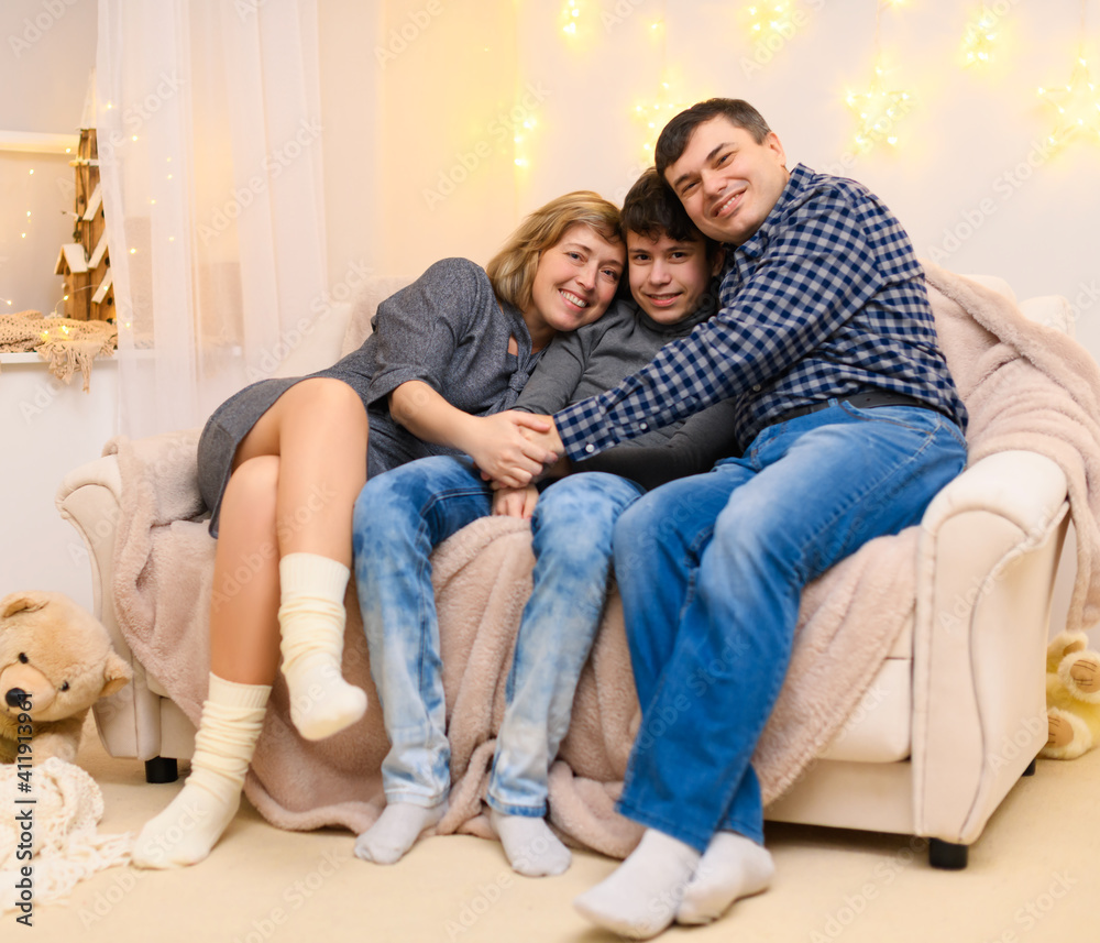 portrait of a family sitting on a sofa at home