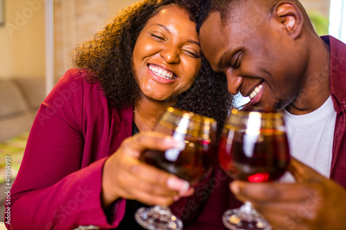 Authentic people african american couple in love drinking wine from glasses and eating italian pasta in living room 14 february valentines day