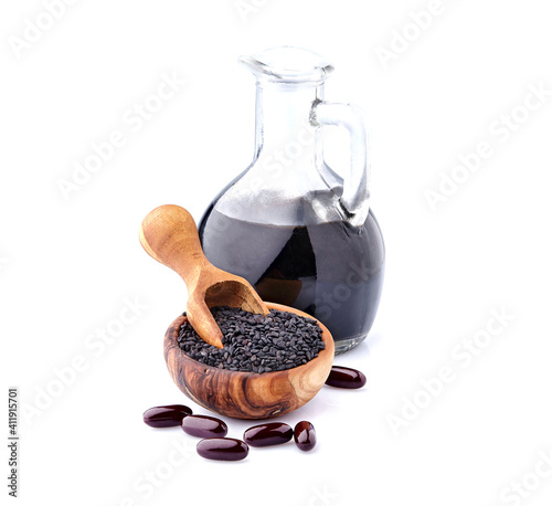 Black cumin oil pill. Nigella sativa. Nigella or Black cumin over white background. photo