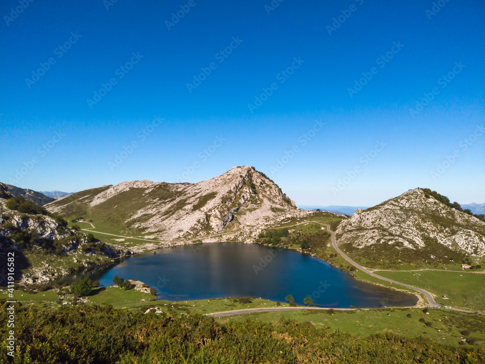 The Lakes of Covadonga. The Lake Enol is a small highland lake in the Principality of Asturias, Spain. It is located in the Picos de Europa Western Massif, Cantabrian Mountains.