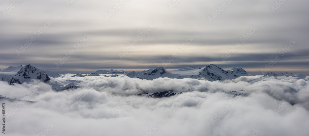 Whistler, British Columbia, Canada. Beautiful Panoramic View of the Canadian Snow Covered Mountain Landscape during a cloudy and vibrant winter day.