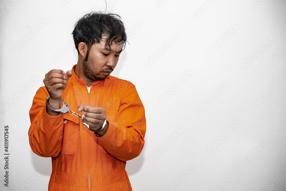 Prisoner in orange robe concept,Portrait of asian handsome man in Prison uniforms,Bandit has a lot of muscle, Prisoner in orange robe concept,Portrait of asian handsome man in Prison uniforms,Bandit has a lot of muscle,