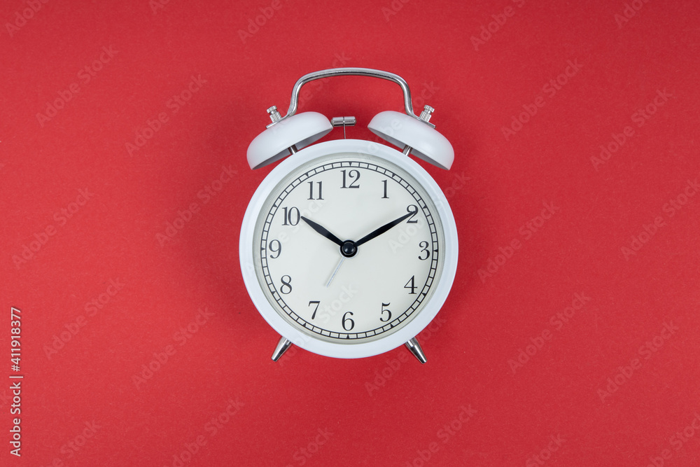 Retro alarm clock on red background. Old fashioned alarm clock Retro alarm clock on red background. Old fashioned alarm clock