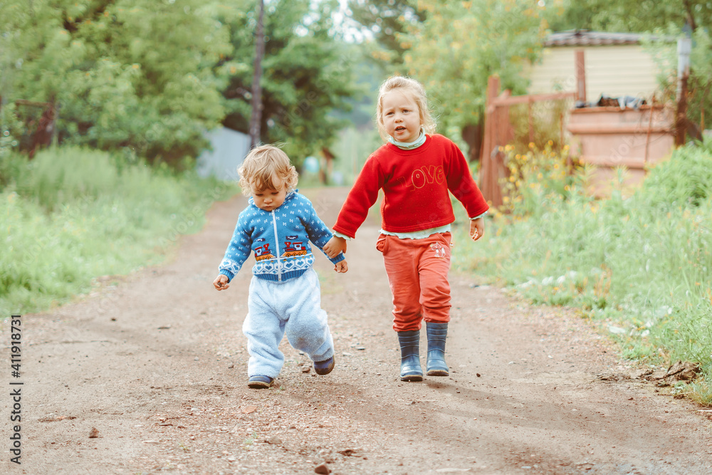 sister and brother walking down the street sister and brother walking down the street