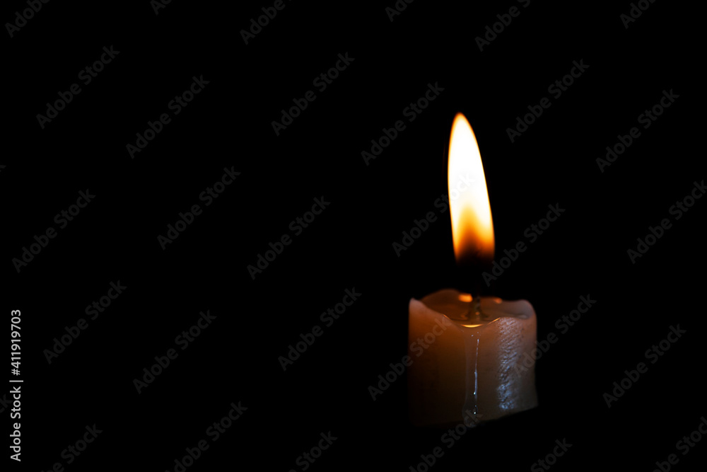 Light candle burning brightly in the black background Light candle burning brightly in the black background