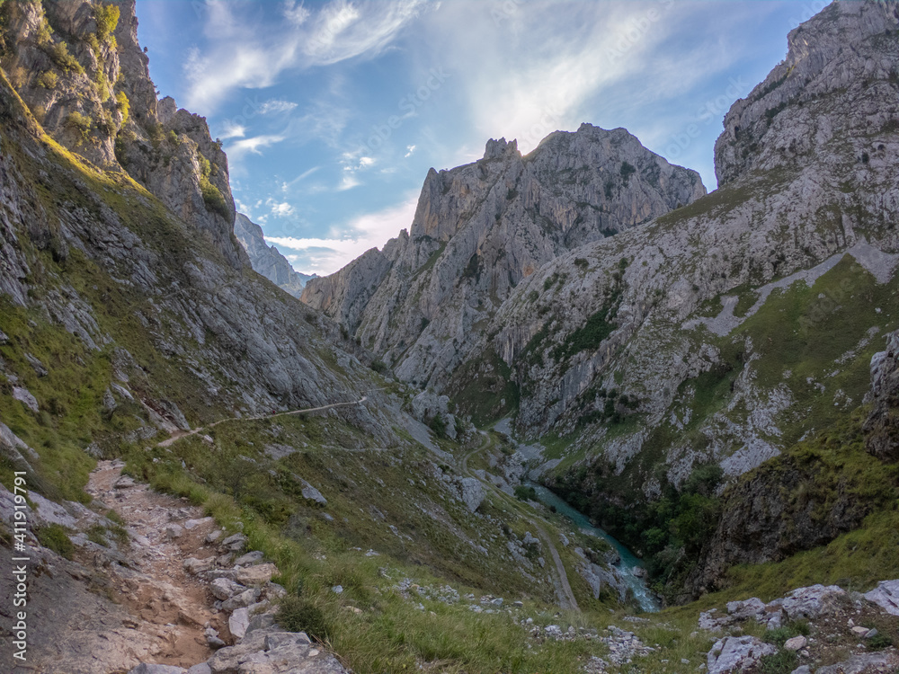 The Cares river canyon along the Cares Route in the heart of Picos de Europa National Park, Spain. Narrow and impressive canyon between cliffs, bridges, caves, footpaths and rocky mountains.
