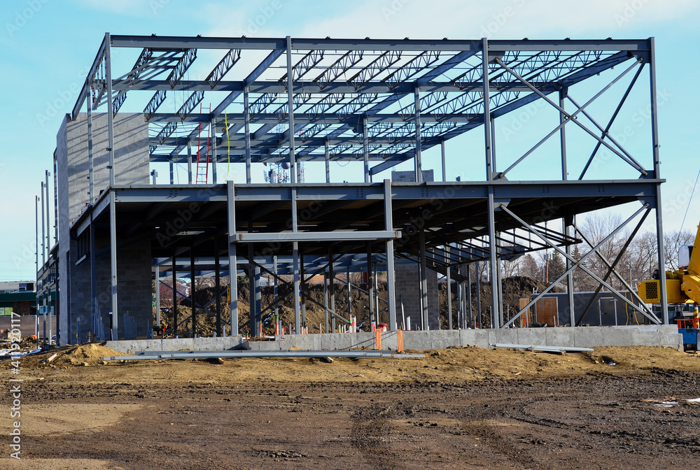 Two story steel frame commercial building under construction in urban area. Two story steel frame commercial building under construction in urban area.