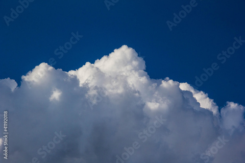 Sunny summer sky with large cumulus clouds.