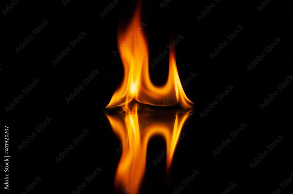 fire flame with reflection in the glass on a black background