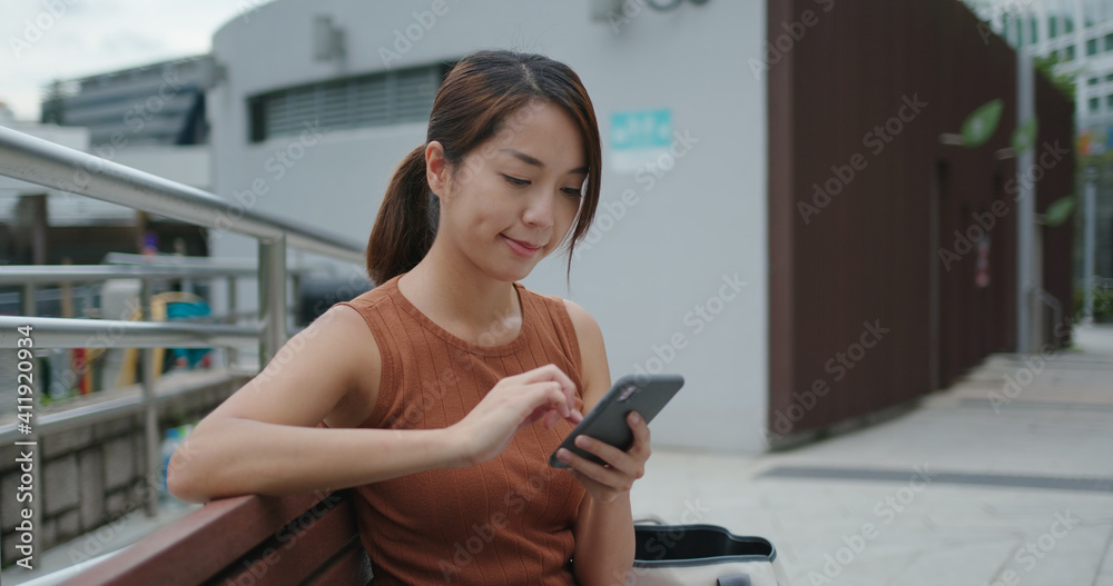 Woman use of mobile phone in city Woman use of mobile phone in city