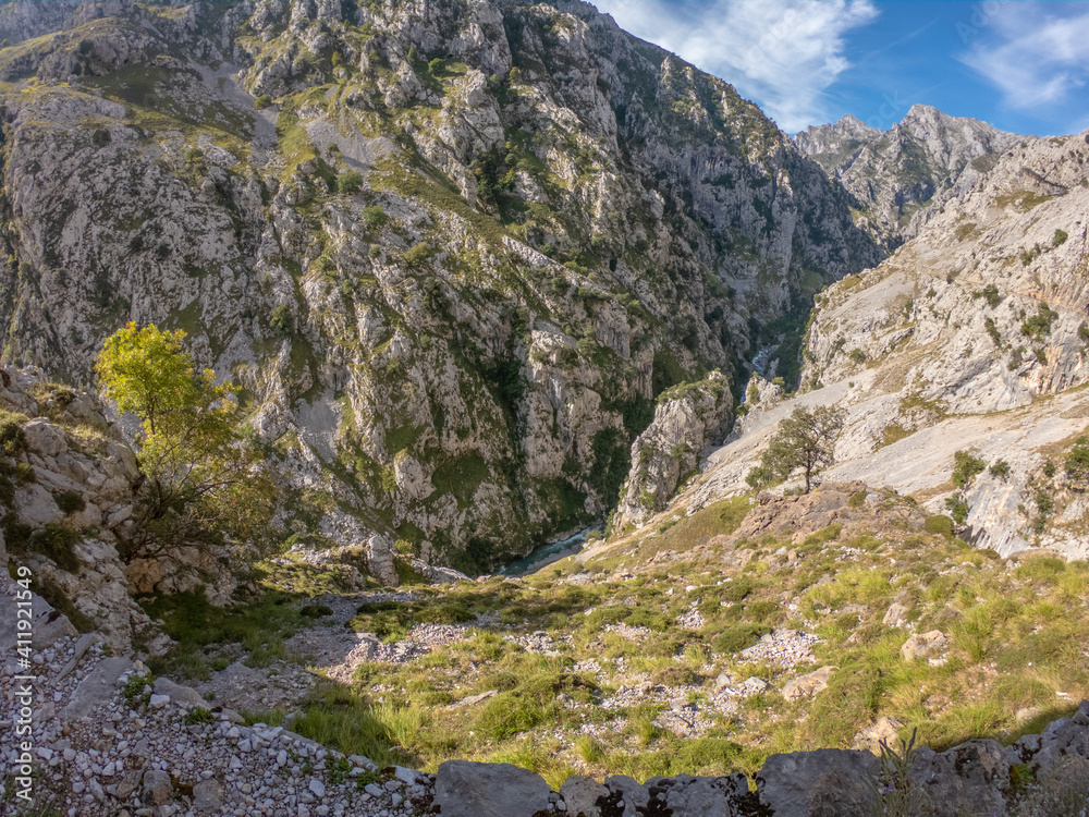 Obraz premium The Cares Route in the heart of Picos de Europa National Park, Cain-Poncebos, Asturias, Spain. Narrow and impressive canyon between cliffs, bridges, caves, footpaths and rocky mountains.