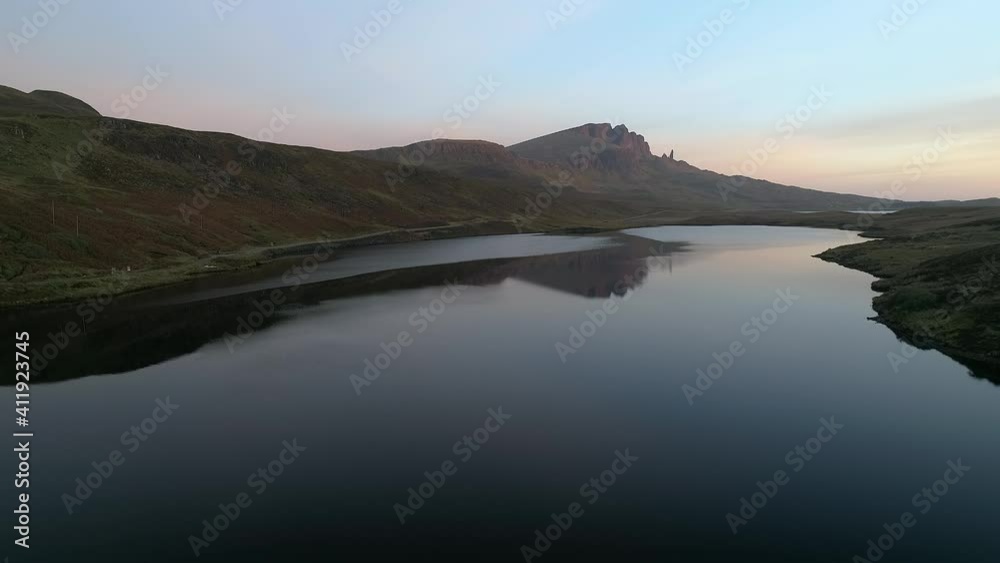 Super wide aerial shot flying near Old Man of Storr above a lake in Isle of Skye Scotland Super wide aerial shot flying near Old Man of Storr above a lake in Isle of Skye Scotland