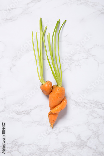 Partial view of an Imperfect carrot on marble background