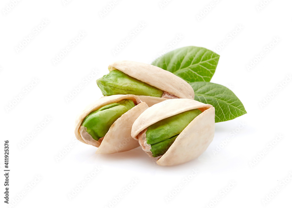 Pistachio nuts with leaves on white background Pistachio nuts with leaves on white background