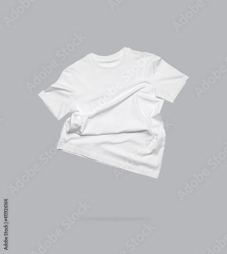 White flying cotton T-shirt isolated on gray background. Clean white t-shirt for women or men. Unisex T-shirt. Branding clothes front view. Mock up for your design