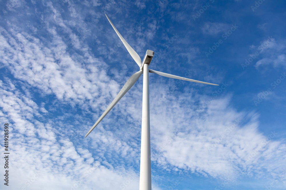 Wind turbine, renewable energy on blue cloudy sky background Wind turbine, renewable energy on blue cloudy sky background