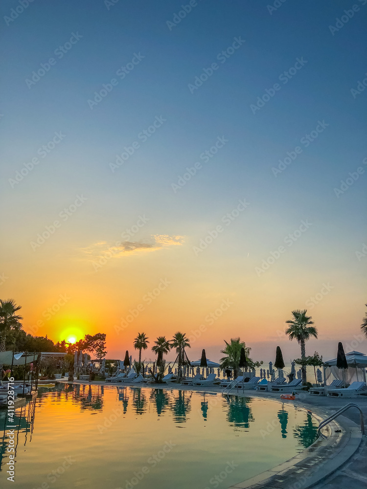  Chalkidiki Greece at summer 2020 during pandemic covid-19 nice blue sea in the pool of the resort  and the colors of the sunset