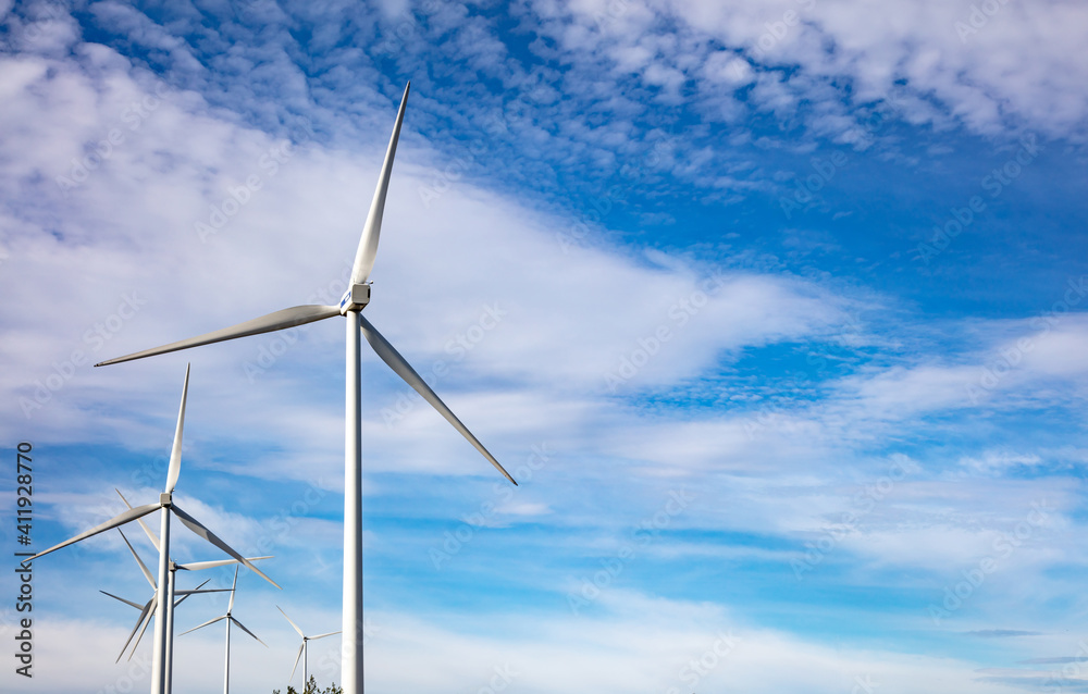 Wind turbines, renewable energy on blue cloudy sky background. Wind farm Wind turbines, renewable energy on blue cloudy sky background. Wind farm
