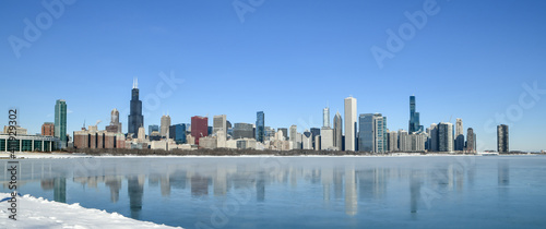 Big city skyline along frozen lakeshore in winter © BradleyWarren