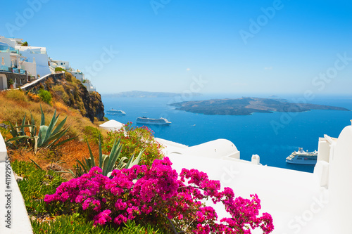 White architecture on Santorini island, Greece. Flowers on the terrace with sea view. Travel destinations concept © smallredgirl