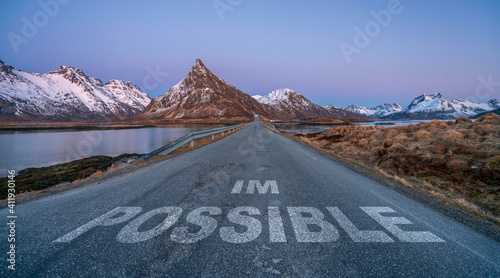 Quadro su tela im possible text quote printed on asphalt road towards the mountains during blue hour
