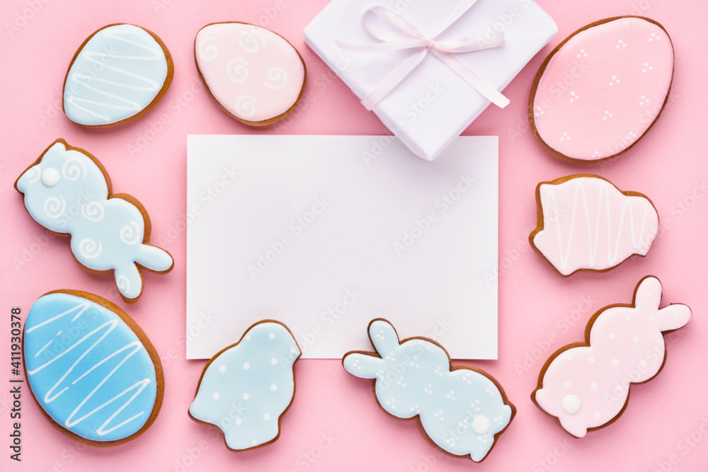 Easter greeting card with colorful rabbits, eggs, chickens and carrots gingerbread cookies on pink background with copy space. Mock up. Banner. Top view. Easter greeting card with colorful rabbits, eggs, chickens and carrots gingerbread cookies on pink background with copy space. Mock up. Banner. Top view.