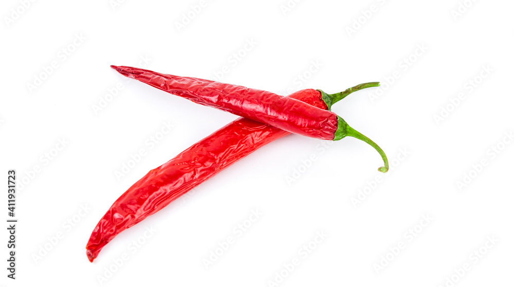 Two red chili peppers lying on a white background. Chilli pepper ready to cook. Two red chili peppers lying on a white background. Chilli pepper ready to cook.