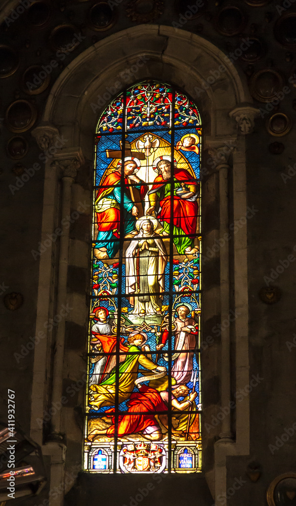 Lourdes, France, 24 June 2019: Colorful stained glass window in the Basilica of the Immaculate Conception in Lourdes,