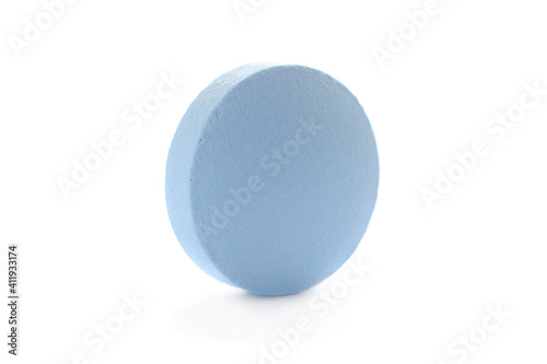 One blue pill close-up, isolated on white background. Macro photo of a blue pill. Blue pill isolated on white background. Close-up, macro. Blue antibiotic pill close up.
