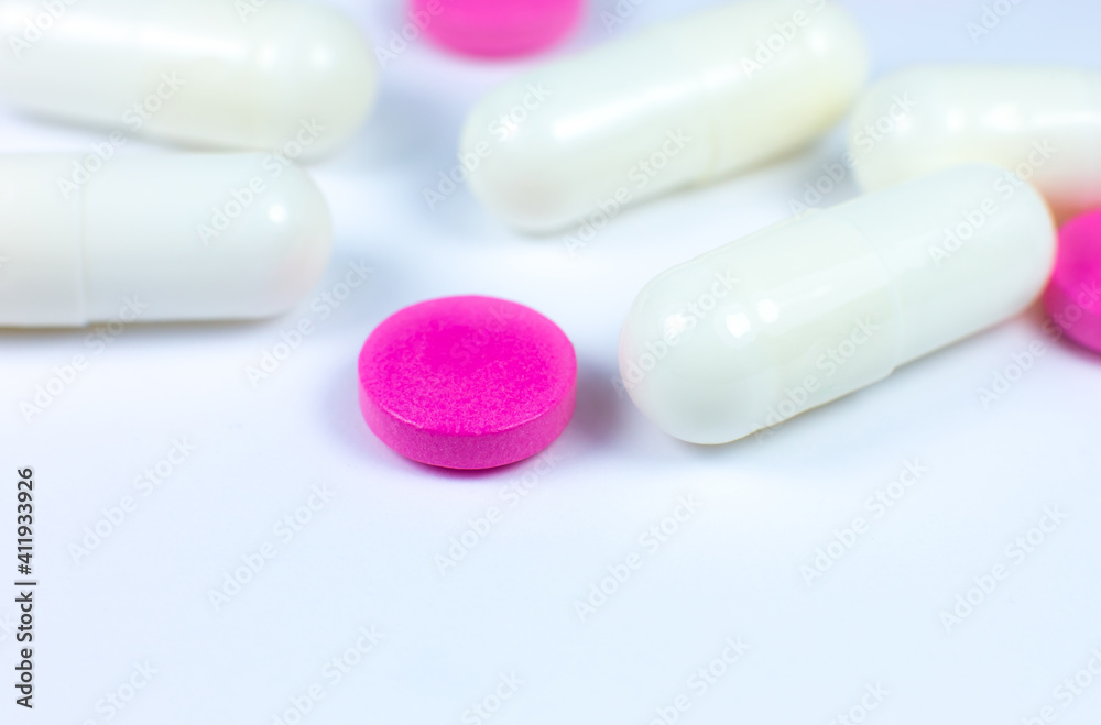 Colored pills on white background. Close up. Medical treatment concept. Colored pills on white background. Close up. Medical treatment concept.