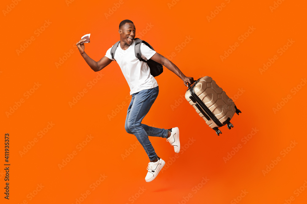 Happy man with passport and suitcase running and looking back Stock Photo |  Adobe Stock