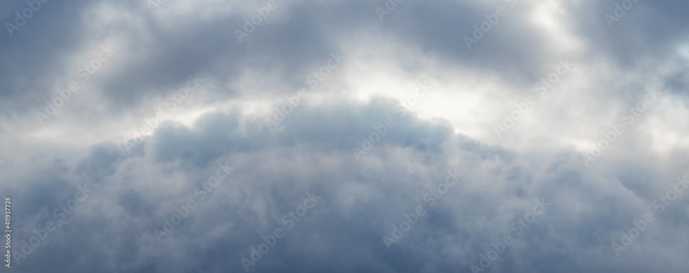 Panorama of the stormy sky covered with continuous clouds