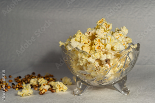 A bowl of salted popcorn on an old table.