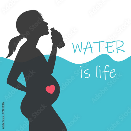 A pregnant woman drinks water from a bottle.