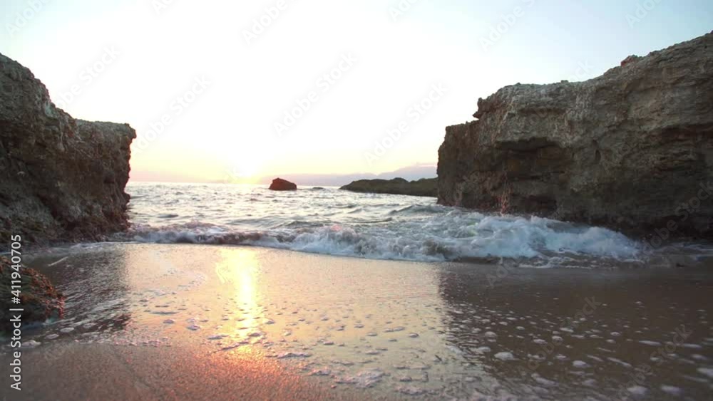 View of waves arriving on sandy beach on sunset. View of waves arriving on sandy beach on sunset.
