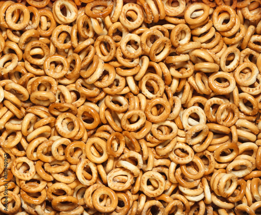 Small bagels sprinkled with sugar background. Traditional Russian pastries. Top view. Small bagels sprinkled with sugar background. Traditional Russian pastries. Top view.