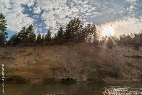 Right high bank with the dreams of the Khoper river. End of the day. Soltske sits down below the horizon. Rafting in the summer on a kayak on the river. Individual hike. Solo.