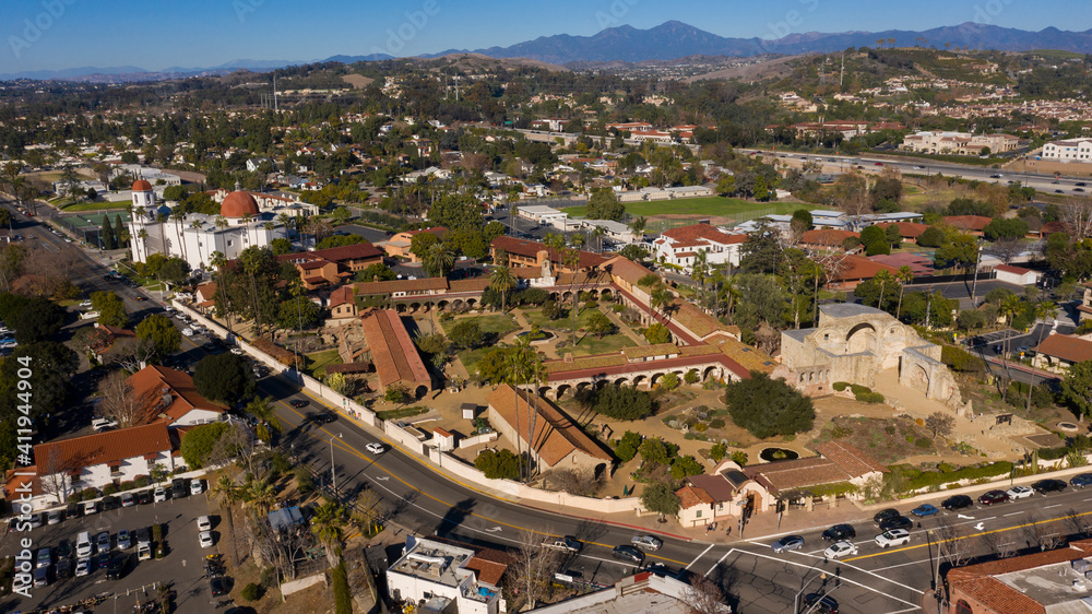 Daytime aerial view of the Spanish Colonial era mission and surrounding city of downtown San Juan Capistrano, California, USA. 