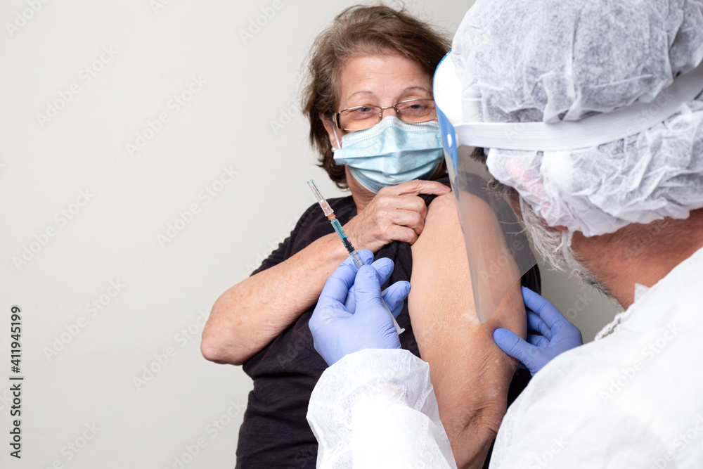 nurse prepares to give injection to patient
