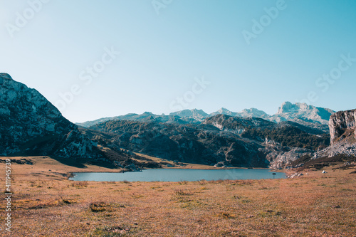 View of glacial Lake Ercina or Lagoa de la Ercina, nestled among marvelous mountain tops, Lakes of Covadonga Track, Cornion Massif, Picos de Europa National Park, Asturias, Spain. photo