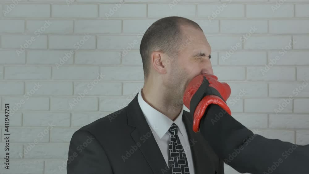 Business knockout. Businessman gets knocked out with a hand in a boxing glove. Knockout in business. Business knockout. Businessman gets knocked out with a hand in a boxing glove. Knockout in business.
