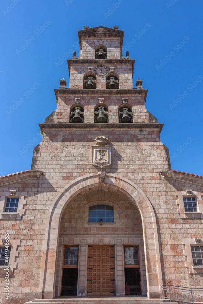 Cangas de Onis, Spain - September 4, 2020: The Church of Our Lady of the Assumption of St. Mary (Iglesia de Nuestra Señora de la Asunción de Santa María) with tower and 6 bells.
