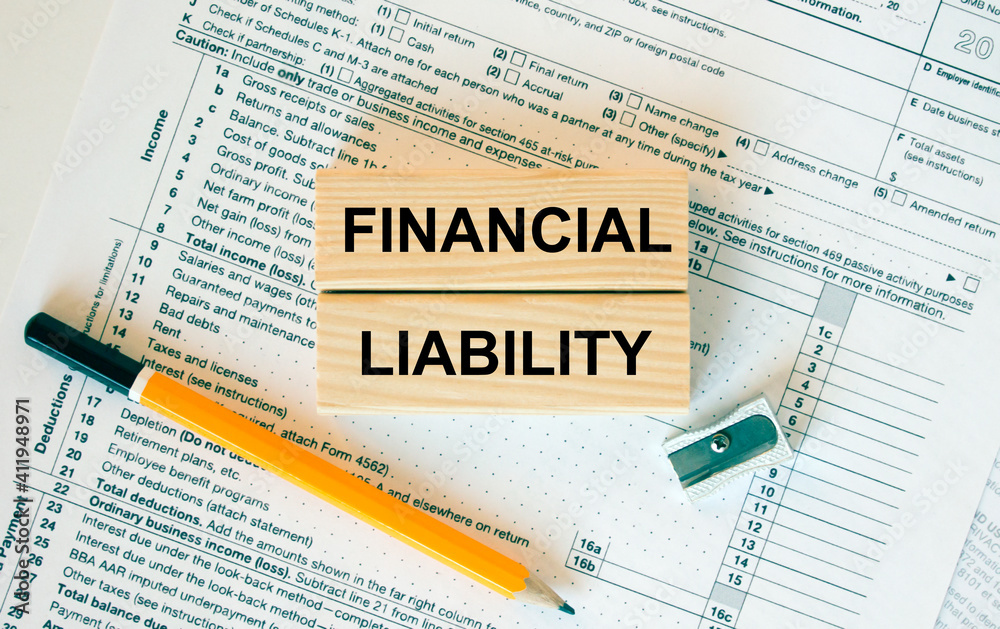 Fototapeta premium Wooden blocks with text Financial Liability on financial docs