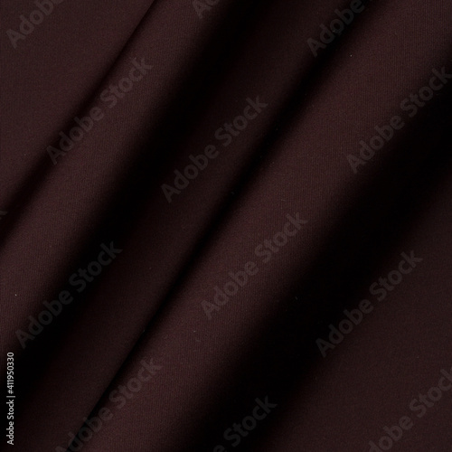 Smooth fabric texture with folds and wawes. Close up silk background