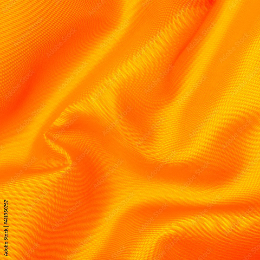 Smooth fabric texture with folds and wawes. Close up silk background