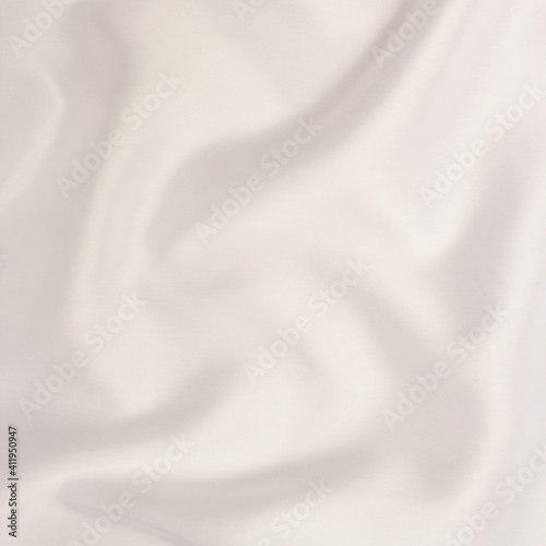 Smooth fabric texture with folds and wawes. Close up silk background