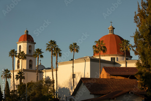 Late afternoon sun shines on the historic Basilica and historic district of San Juan Capistrano, California, USA.